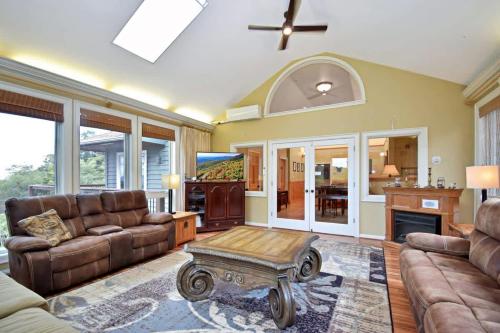 a living room with a couch and a coffee table at Boone Mountain Getaway- Hot Tub Firepit in Boone