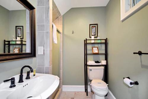 a bathroom with a sink and a toilet and a mirror at Boone Mountain Getaway- Hot Tub Firepit in Boone