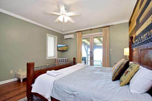 a bedroom with a bed with a ceiling fan at Boone Mountain Getaway- Hot Tub Firepit in Boone