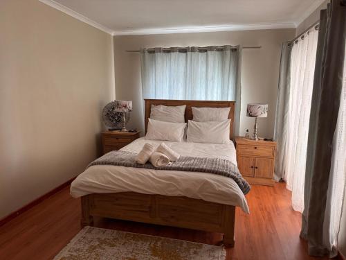 a bedroom with a bed with two towels on it at 2 Bedroom City Center Haven! in Swakopmund