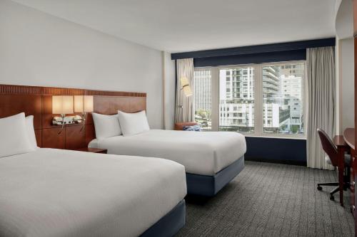 a hotel room with two beds and a window at Courtyard by Marriott Halifax Downtown in Halifax