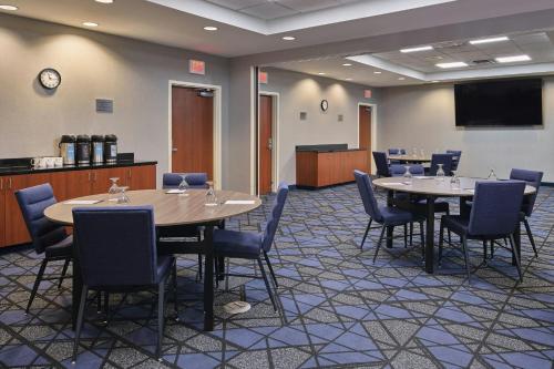 a conference room with tables and chairs and a screen at Courtyard by Marriott Halifax Downtown in Halifax