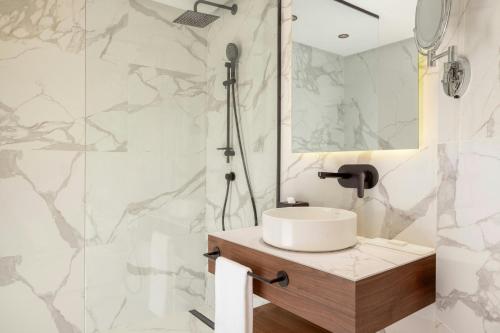 a bathroom with a sink and a shower at Le Meridien N'fis in Marrakech