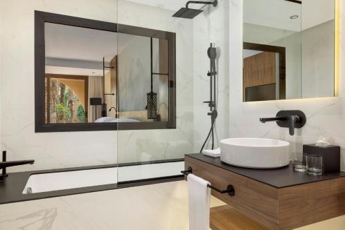 a bathroom with a sink and a mirror at Le Meridien N'fis in Marrakech