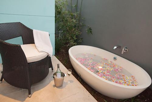 a bath tub covered in sprinkles in a bathroom at Cavvanbah - April Sun Villa in Byron Bay