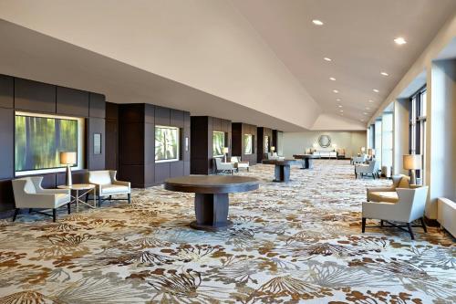 a lobby with a table and chairs and a rug at The Westin Trillium House, Blue Mountain in Blue Mountains