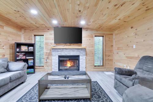 a living room with a fireplace and a flat screen tv at Relax in Blakeslee - Spacious 5BR Home with BBQ in Blakeslee