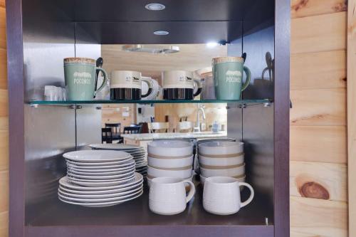 a shelf filled with plates and cups and dishes at Relax in Blakeslee - Spacious 5BR Home with BBQ in Blakeslee