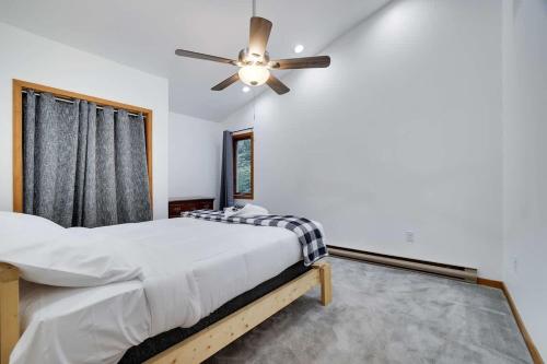 a bedroom with a bed and a ceiling fan at Relax in Blakeslee - Spacious 5BR Home with BBQ in Blakeslee