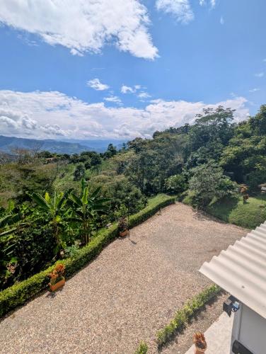 a view of the mountains from the balcony of a house at Finca Boutique Los Laureles Villeta in Villeta