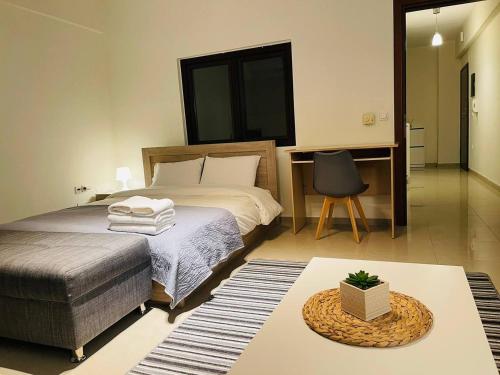 a bedroom with a bed and a chair and a table at Beauty Home Orestiada Center in Orestiada