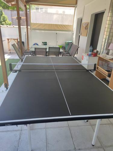 a ping pong table in the middle of a room at Beauty Home Orestiada Center in Orestiada