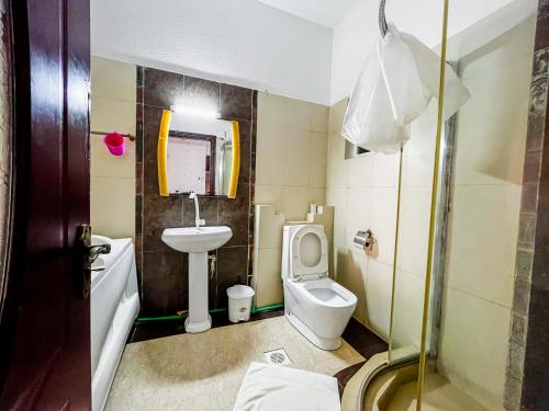 a bathroom with a toilet and a sink at Serene Sea View One Bedroom Apt Shanzu in Mombasa