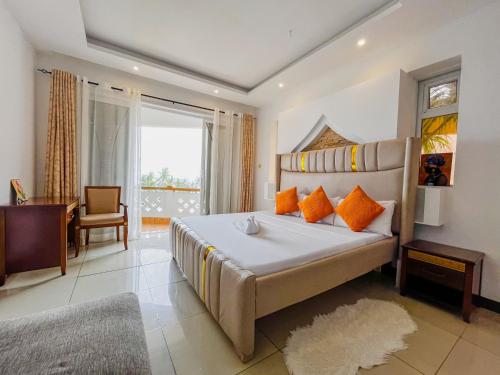 a bedroom with a large bed with orange pillows at Serene Sea View One Bedroom Apt Shanzu in Mombasa