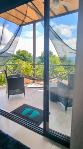 a view of a room with a pool through a window at Finca Boutique Los Laureles Villeta in Villeta