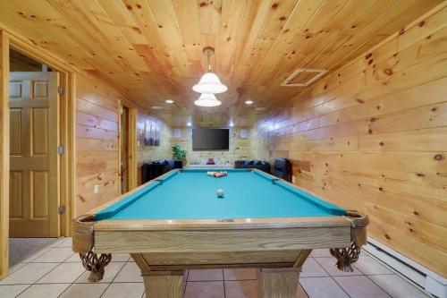 a pool table in a room with wooden walls at Modern 6BR Cabin- Hot Tub Theater Basketball in White Haven