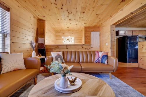a living room with a couch and a table at Modern 6BR Cabin- Hot Tub Theater Basketball in White Haven