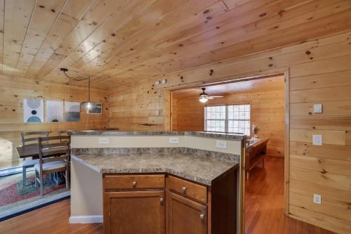 a kitchen and dining room in a log cabin at Modern 6BR Cabin- Hot Tub Theater Basketball in White Haven