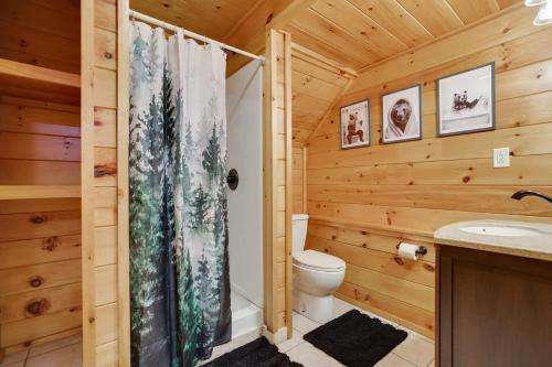 a wooden bathroom with a toilet and a shower at Modern 6BR Cabin- Hot Tub Theater Basketball in White Haven