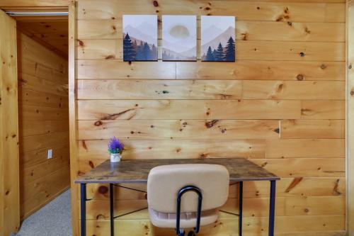a wooden wall with a table and a chair at Modern 6BR Cabin- Hot Tub Theater Basketball in White Haven