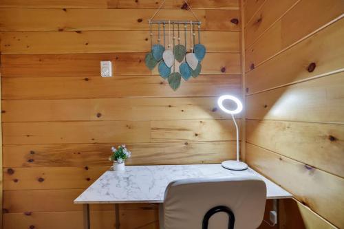 a room with a desk with a lamp and a chair at Modern 6BR Cabin- Hot Tub Theater Basketball in White Haven