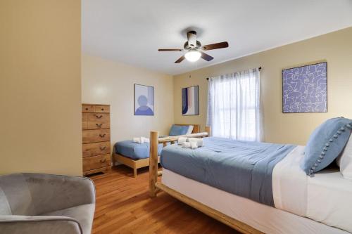 a bedroom with two beds and a ceiling fan at Modern 6BR Cabin- Hot Tub Theater Basketball in White Haven