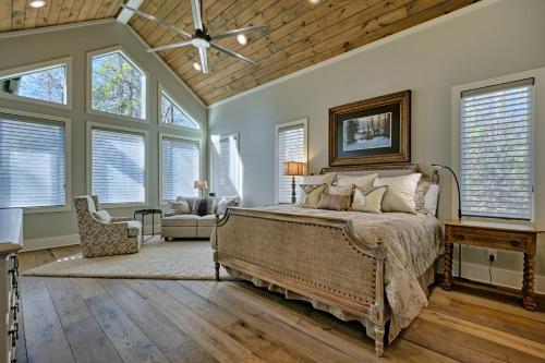 a bedroom with a large bed in a room with windows at Dancing Bear Walk to Town in Highlands
