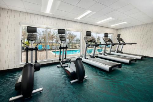 a row of treadmills in a gym with a swimming pool at TownePlace Suites by Marriott Montgomery EastChase in Montgomery