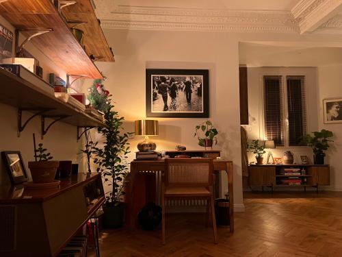 un salon avec une table et un bureau dans l'établissement Bel appartement Paris Montmartre, à Paris