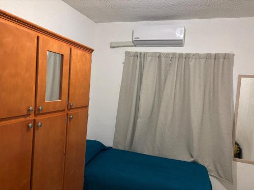 チワワにあるCasita Blue al norteのベッドとドレッサーと窓のある寝室