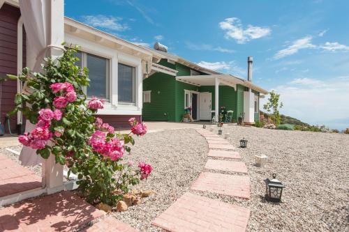 a house with pink flowers in front of it at Ktima Noosfera Wellness & Retreat Center in Nees Vrisoules