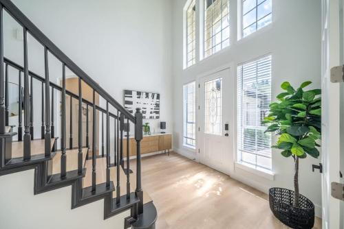 a hallway with a staircase and a potted plant at Austin Spacious Haven - Pool Jacuzzi Firepit in Bee Cave