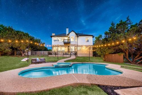 a house with a swimming pool in the yard at Austin Spacious Haven - Pool Jacuzzi Firepit in Bee Cave