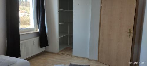 a room with a closet with a door and a window at Gemütliche 3 Zimmer Wohnung in Gottmadingen