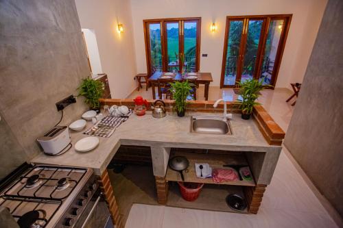 an overhead view of a kitchen with a stove and sink at SHD Paddy Villa in Talpe