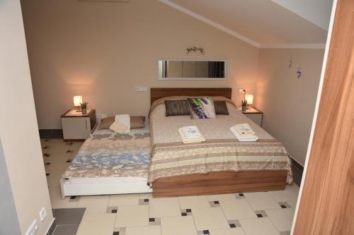 a bedroom with a large bed in a room at Apartments Lavendula in Vodice