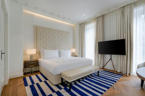 a hotel room with a bed and a television at El Autor Hotel, Madrid, Autograph Collection in Madrid