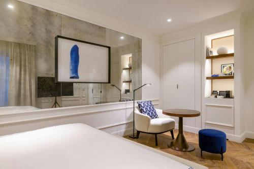 a bedroom with a bed and a table and a chair at El Autor Hotel, Madrid, Autograph Collection in Madrid