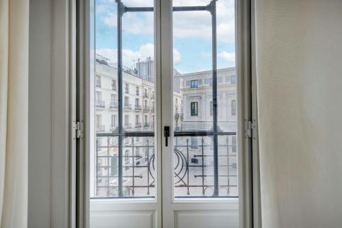 an open window with a view of a city at El Autor Hotel, Madrid, Autograph Collection in Madrid