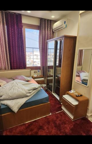 a bedroom with a bed and a large mirror at HOTEl Mansoura University Private in Mansoura