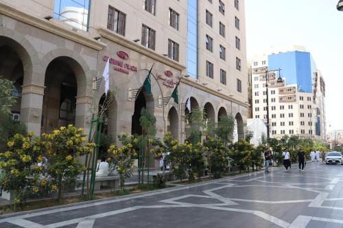 a street in a city with buildings and flowers at Crowne Plaza Madinah by IHG in Al Madinah