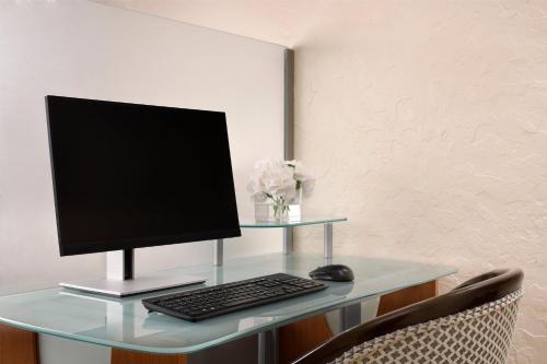 a computer monitor and a keyboard and mouse on a desk at Crowne Plaza Madinah by IHG in Al Madinah