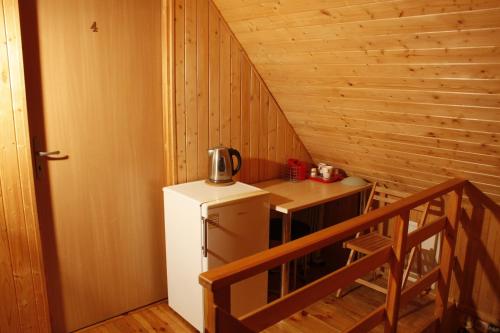a small kitchen with a refrigerator and a table at The Jolly Man in Vilnius