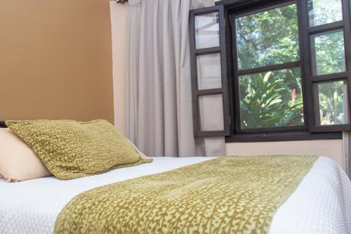Ένα ή περισσότερα κρεβάτια σε δωμάτιο στο Hotel Hacienda Gualiqueme