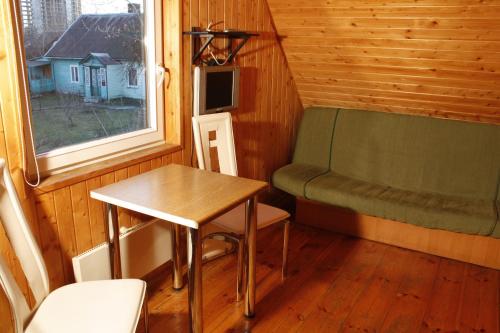 a small room with a table and a chair and a window at The Jolly Man in Vilnius