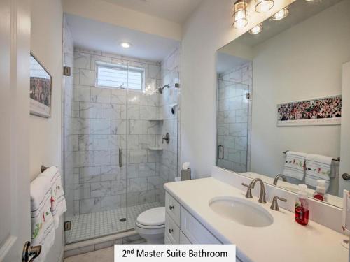 a bathroom with a sink and a shower with a mirror at Oceanside Single Family Brant Beach Beach Badges Rooftop Deck Wifi Private Yard Washer & Dryer in Beach Haven Crest