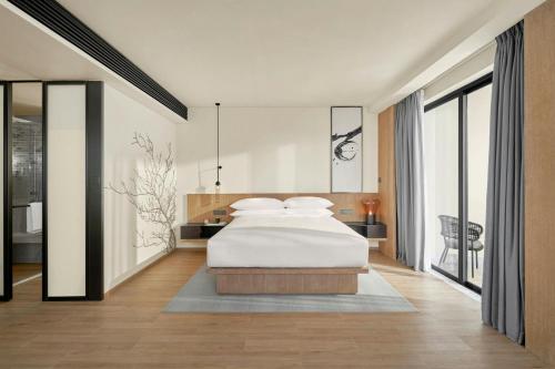 a bedroom with a large white bed in it at Fairfield by Marriott South Binh Duong in Thuan An