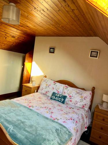 a bedroom with a bed with a pillow with a girls strike sign at The Burren Coach House in Bealaclugga
