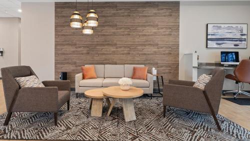 a living room with a couch and two chairs and a table at Candlewood Suites Perry-National Fairground Area by IHG in Perry