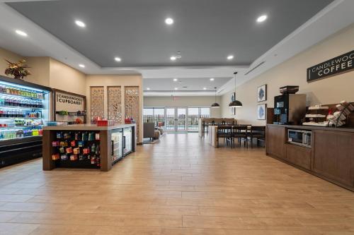 a lobby of a store with a counter and a restaurant at Candlewood Suites Perry-National Fairground Area by IHG in Perry